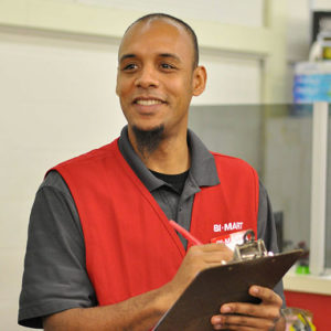 Bi-Mart Employee holding clipboard