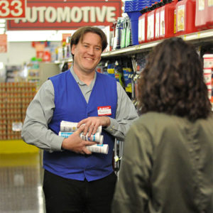 Bi-Mart employee smiling and talking to customer