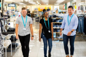 Kohl's employees walking through store smiling